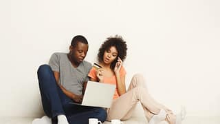 couple with laptop and credit card ZBP.width