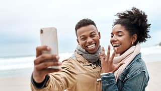 engaged couple on beach.width