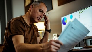 middle aged man serious looking at documents gettyimages