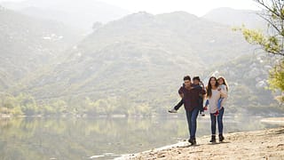 parents carrying young kids on hike hBSNf.width .jpg