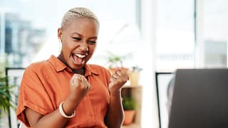 person celebrating victory while looking at computer
