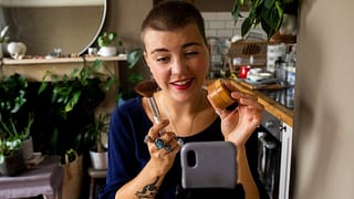 person holding makeup while recording on phon.width CHWzapr