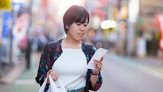 person with groceries and receipt NNaHY.width