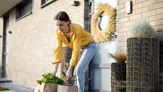 person with grocery bags at front door iQIVah.width .jpg