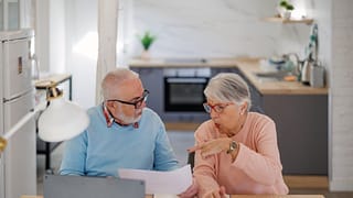 senior couple at a desk serious gettyimages