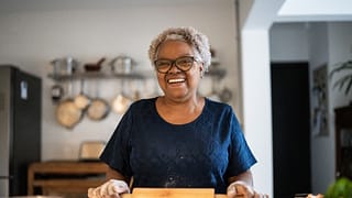 senior woman baking a smiling person holding a rolling pin gettyimages