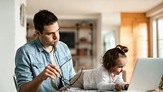 stressed dad working at home with baby.width