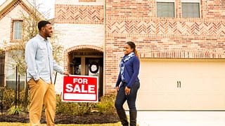 two people in front of house for sale PvidXF.width