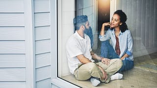 two people sitting on the floor and talking n.width IwLAY