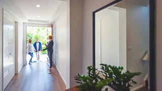 two people walking into house with realtor hd.width