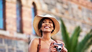 woman s smiling holding a camera gettyimages