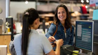 woman paying with credit card in department s.width tBfvJX
