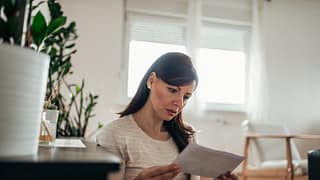 worried woman reading letter.width .jpg