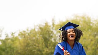 young smiling woman on graduation day wearing.width