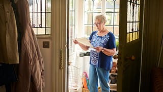 Elderly woman appears concerned about letter .width qNgArMh.jpg