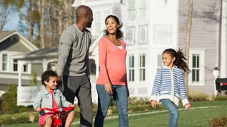 Family walking through suburban neighborhood .width .jpg