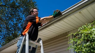 Man cleaning homes gutters fPDNzI.width .jpg