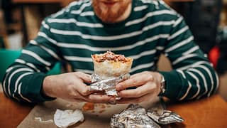 Man enjoying a burrito. JiUnfG.width .jpg