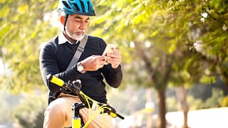 Man looking at his cell phone while riding hi.width TIdVD.jpg
