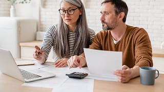 Mature couple working on tax preparation lON.width .jpg