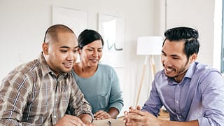 Mortgage lender goes over documents with coup.width Omt.jpg