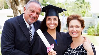 Parents with college student at graduation .width hEWEQM.jpg