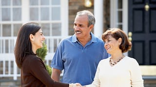 Realtor shaking hands with mature couple outs.width dGtEi.jpg
