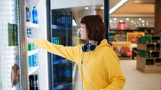 Shopper selecting beverage from a drink coole.width .jpg