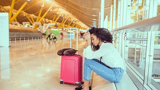 Upset woman at airport eSPPDv.width .jpg