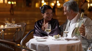 Well dressed mature couple enjoying wine with.width Uwlolj.jpg