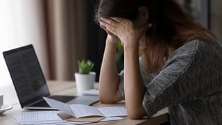 Woman appearing upset with head in her hands .width qqzych.jpg