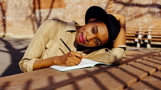 Woman in park writing in journal QsKsNb.width .jpg