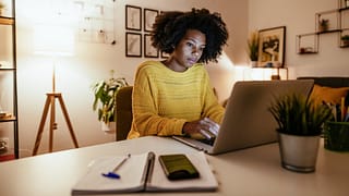 Woman using laptop at home for work or study .width .jpg