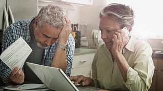 Worried looking mature couple with documents .width CCbZqgy.jpg