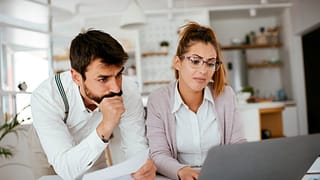 Young couple skeptically looks at information.width DDgOhN.jpg