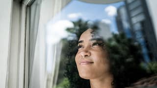 a person looking out the window smiling.jpg