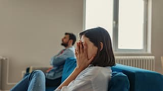 couple having an argument on couch.width .jpg