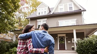 couple in front of new house.width .jpg