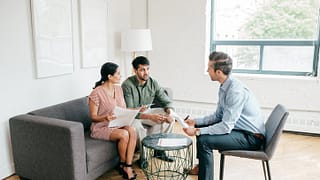 couple with realtor and paperwork KsVHLK.width .jpg