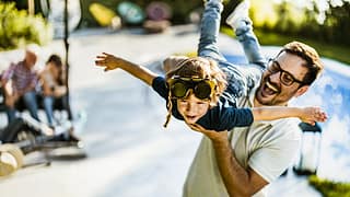 dad holding son in air FBKHHl.width .jpg