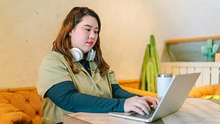 female college student at home on laptop.width .jpg