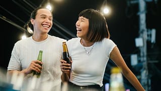 man and woman drinking beer on rooftop FlmiMS.width .jpg