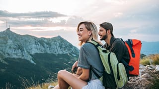 man and woman hikers on mountaintop.width .jpg