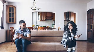 man and woman sitting at opposite ends of a c.width okzr.jpg