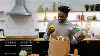 man in kitchen with groceries GPjuoM.width .jpg