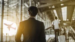 man with suitcase in airport XNAsLY.width .jpg