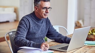 middle aged man notes laptopgettyimages .jpg