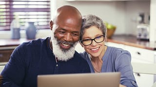 older couple at laptop smiling gettyimages .jpg
