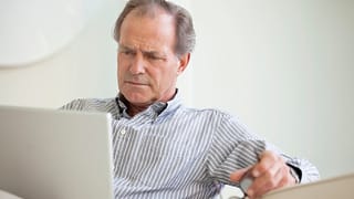 older man laptop serious expression looks unhappy gettyimages .jpg