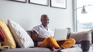 older adult on couch with laptop nNXo.width .jpg